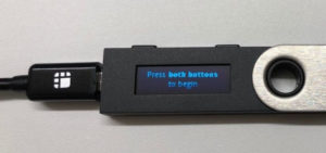 Press both buttons to begin on Ledger Nano S